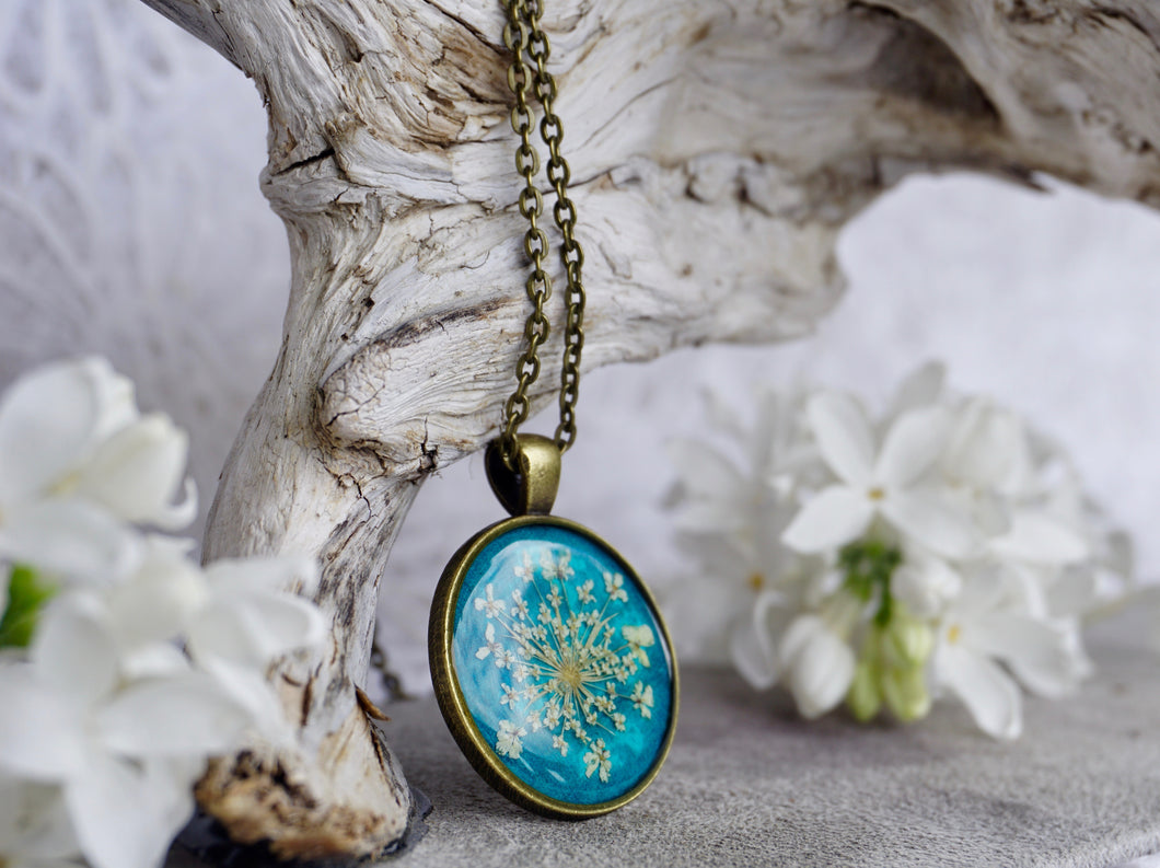 Real Pressed Queen Annes Lace Antique Bronze Pendant on Teal Background by Pressed Wishes; Proudly handmade in Canada
