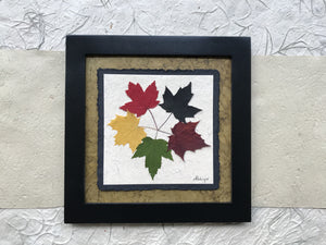 the tattoo pressed maple leaf artwork with green handmade paper and a black frame