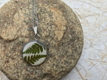 pressed fern pendant sealed in eco resin; stainless steel circle pendant