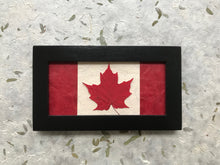 maple leaf in canadian flag design in black frame; handcrafted in canada